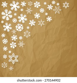 Snowflakes in the corner paper on crumpled paper brown background