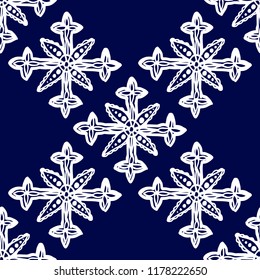 Snowflakes in ethnic style. Seamless pattern. For winter, New Year, Christmas projects. Abstract silhouette. Indian, Native American Aztec. White elements, blue background
