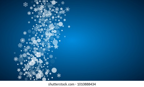 Snowflakes falling on blue background. Christmas and New Year horizontal theme. Frosty falling snowflakes for banners, gift card, party invitation, compliments and special business offer