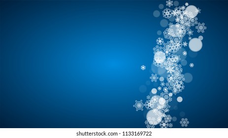 Snowflakes falling on blue background. Christmas and New Year horizontal theme. Frosty falling snowflakes for banners, gift card, party invitation, compliments and special business offer