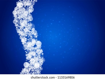 Snowflakes falling on blue background with sparkles. Christmas and New Year horizontal theme. Frosty falling snowflakes for banners, gift card, party invitation, compliments and special business offer