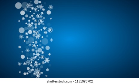 Snowflakes falling on blue background. Christmas and New Year horizontal theme. Frosty falling snowflakes for banners, gift card, party invitation, compliments and special business offer