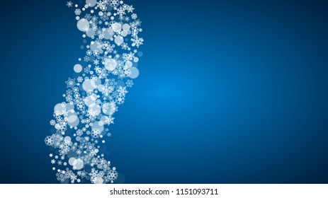 Snowflakes falling on blue background. Christmas and New Year horizontal theme. Frosty falling snowflakes for banners, gift card, party invitation, compliments and special business offer