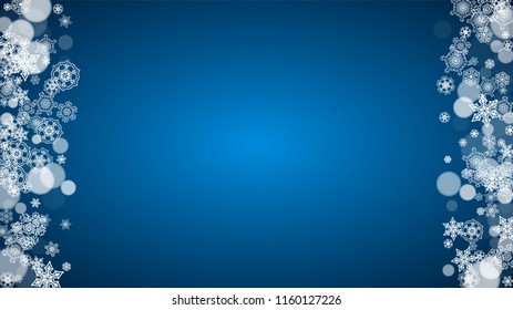 Snowflakes falling on blue background. Christmas and New Year horizontal theme. Frosty falling snowflakes for banners, gift card, party invitation, compliments and special business offer