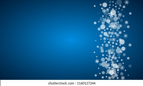 Snowflakes falling on blue background. Christmas and New Year horizontal theme. Frosty falling snowflakes for banners, gift card, party invitation, compliments and special business offer