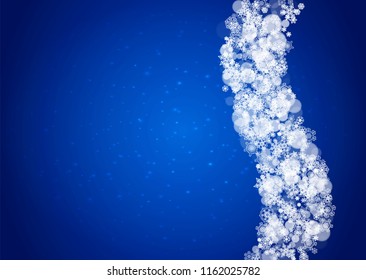 Snowflakes falling on blue background with sparkles. Christmas and New Year horizontal theme. Frosty falling snowflakes for banners, gift card, party invitation, compliments and special business offer