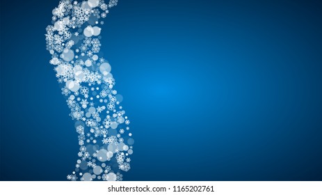 Snowflakes falling on blue background. Christmas and New Year horizontal theme. Frosty falling snowflakes for banners, gift card, party invitation, compliments and special business offer