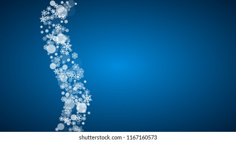 Snowflakes falling on blue background. Christmas and New Year horizontal theme. Frosty falling snowflakes for banners, gift card, party invitation, compliments and special business offer