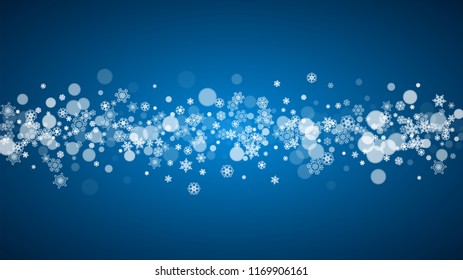 Snowflakes falling on blue background. Christmas and New Year horizontal theme. Frosty falling snowflakes for banners, gift card, party invitation, compliments and special business offer