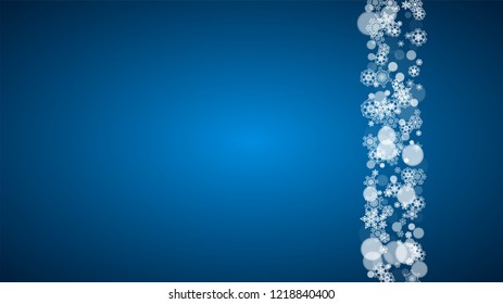 Snowflakes falling on blue background. Christmas and New Year horizontal theme. Frosty falling snowflakes for banners, gift card, party invitation, compliments and special business offer