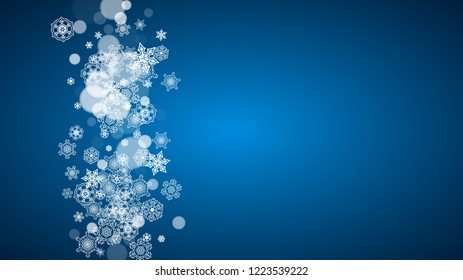 Snowflakes falling on blue background. Christmas and New Year horizontal theme. Frosty falling snowflakes for banners, gift card, party invitation, compliments and special business offer