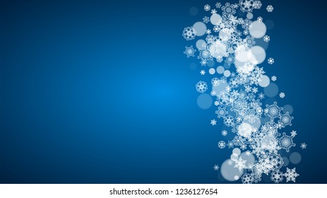 Snowflakes falling on blue background. Christmas and New Year horizontal theme. Frosty falling snowflakes for banners, gift card, party invitation, compliments and special business offer