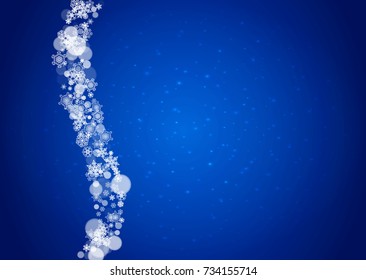 Snowflakes falling on blue background with sparkles. Christmas and New Year horizontal theme. Frosty falling snowflakes for banners, gift card, party invitation, compliments and special business offer