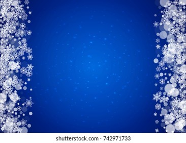 Snowflakes falling on blue background with sparkles. Christmas and New Year horizontal theme. Frosty falling snowflakes for banners, gift card, party invitation, compliments and special business offer