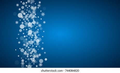 Snowflakes falling on blue background. Christmas and New Year horizontal theme. Frosty falling snowflakes for banners, gift card, party invitation, compliments and special business offer