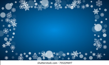 Snowflakes falling on blue background. Christmas and New Year horizontal theme. Frosty falling snowflakes for banners, gift card, party invitation, compliments and special business offer