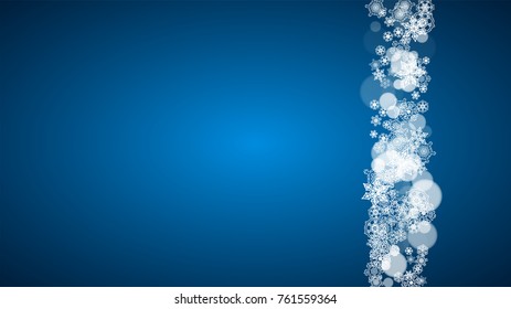 Snowflakes falling on blue background. Christmas and New Year horizontal theme. Frosty falling snowflakes for banners, gift card, party invitation, compliments and special business offer