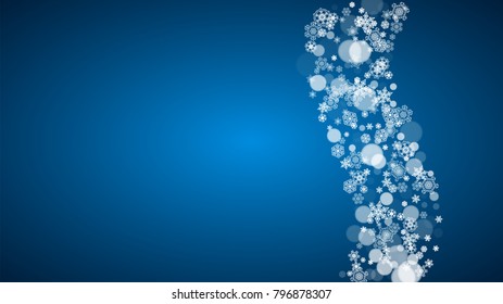 Snowflakes falling on blue background. Christmas and New Year horizontal theme. Frosty falling snowflakes for banners, gift card, party invitation, compliments and special business offer
