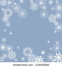 Snowflakes falling on a blue sky background. Winter vector background. The effect of decorating snowflakes. The winter vacation. Well suited for a Christmas card, banner or poster. EPS 10