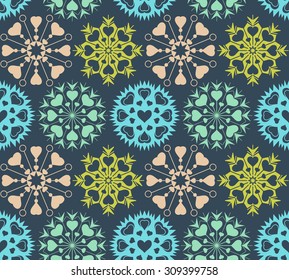 Snowflakes, heart view seamless pattern. Winter, Christmas, Valentine day, birthday texture. Stylized unusual light ornament with heart signs on dark blue background. Vector illustration.
