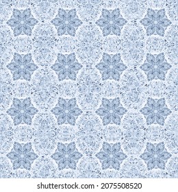 Snowflakes lie on a frosty background. Light pattern. Blue shades.