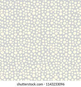 Snowflakes on a gray background seamless vector pattern. White irregular shaped dots. Scattered dots pattern. Perfect as background for Christmas. christmas packaging, cards, gift wrap.