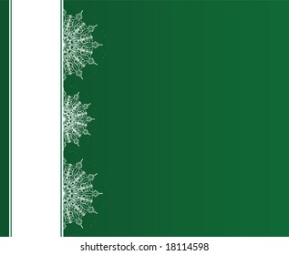 Snowflakes on green background. Copy space included.