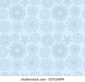 Snowflakes on light blue background. Winter ornament. Seamless pattern. Vector illustration