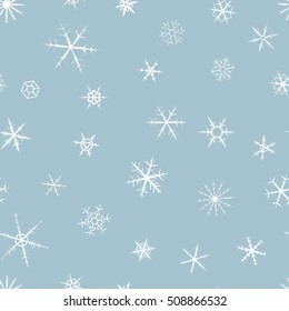Snowflakes on winter gray sky background.Seamless ornament.