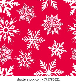 Snowflakes pattern on red background. Seamless winter background.