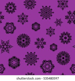 Snowflakes pattern in purple colors. Vector seamless pattern with stylized snowflakes.