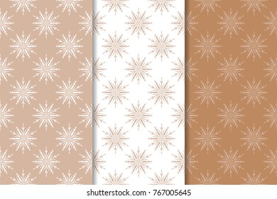 Snowflakes patterns. Set of brown and white seamless backgrounds with christmas elements for wallpapers and textile. Vector illustration