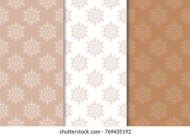 Snowflakes patterns. Set of brown and white seamless backgrounds with christmas elements for wallpapers and textile. Vector illustration