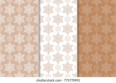 Snowflakes patterns. Set of brown and white seamless backgrounds with christmas elements for wallpapers and textile. Vector illustration