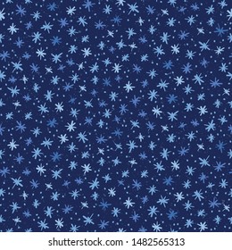 Snowflakes seamless pattern. Hand drawn abstract winter snowfall. Stylish crystal stars on indigo background. Elegant holiday all over print.