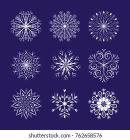 Snowflakes set on dark blue background. Winter Holidays Decorative design elements.