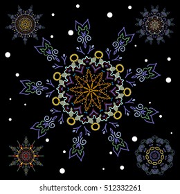 Snowflakes set. Vector sketch with blue and yellow snowflakes on black background.