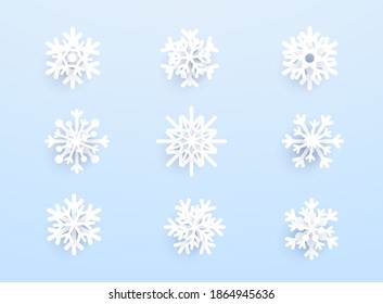Snowflakes with shadow on blue background. Vector set of white Christmas paper cut 3d snowflakes.