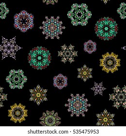 Snowflakes, snowfall in blue, neutral and green colors on a black background. Design. Stock vector illustration falling snow.