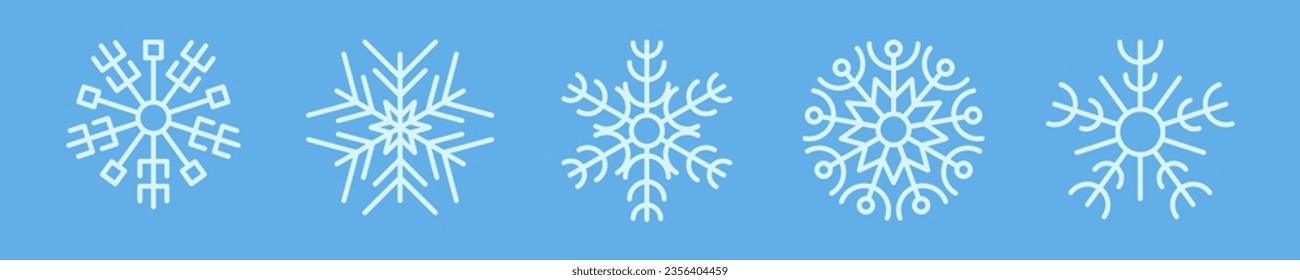 Recogida de copos de nieve en invierno. Conjunto de cinco copos de nieve blancos con estilo de línea sobre fondo azul. Elementos decorativos de Navidad y Año Nuevo. Ilustración del vector