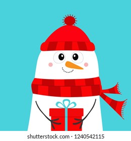 Snowman holding gift box present. Carrot nose, red hat, red scarf. Merry Christmas. Happy New Year. Cute cartoon funny kawaii character. Blue winter background. Greeting card. Flat design. Vector