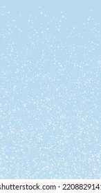 Snowy christmas background. Subtle flying snow flakes and stars on light blue winter backdrop. Delicate sweet snowy christmas. Vertical vector illustration.