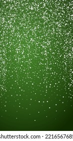 Snowy christmas background. Subtle flying snow flakes and stars on christmas green background. Delicate sweet snowy christmas. Vertical vector illustration.