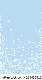 Snowy christmas background. Subtle flying snow flakes and stars on light blue winter backdrop. Delicate sweet snowy christmas. Vertical vector illustration.