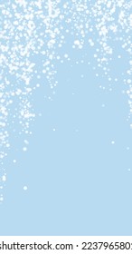Snowy christmas background. Subtle flying snow flakes and stars on light blue winter backdrop. Delicate sweet snowy christmas. Vertical vector illustration.