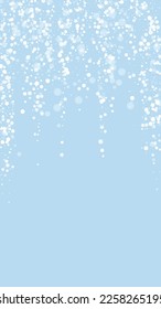 Snowy christmas background. Subtle flying snow flakes and stars on light blue winter backdrop. Delicate sweet snowy christmas. Vertical vector illustration.