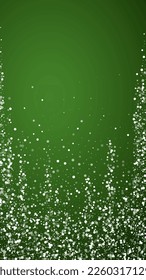 Snowy christmas background. Subtle flying snow flakes and stars on christmas green background. Delicate sweet snowy christmas. Vertical vector illustration.
