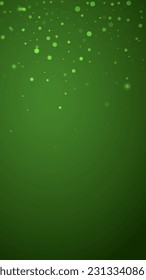 Snowy christmas background. Subtle flying snow flakes and stars on christmas green background. Delicate sweet snowy christmas. Vertical vector illustration.