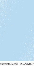 Snowy christmas background. Subtle flying snow flakes and stars on light blue winter backdrop. Delicate sweet snowy christmas. Vertical vector illustration.