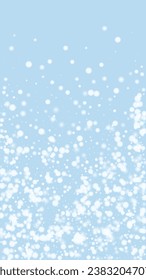 Snowy christmas background. Subtle flying snow flakes and stars on light blue winter backdrop. Delicate sweet snowy christmas. Vertical vector illustration.